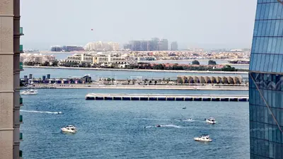 a group of boats in the water near a city at Elan Rimal Bahar Suites, 1min walk to the Sea! Prime location JBR Beach Front in Dubai