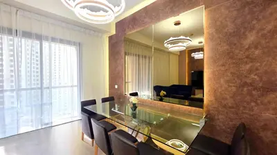 a dining room with a table and chairs and a mirror at Elan Rimal Bahar Suites, 1min walk to the Sea! Prime location JBR Beach Front in Dubai