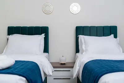 two beds sitting next to each other in a bedroom at Luxury 3BR in Mada Residences - Walk to Dubai Mall in Dubai