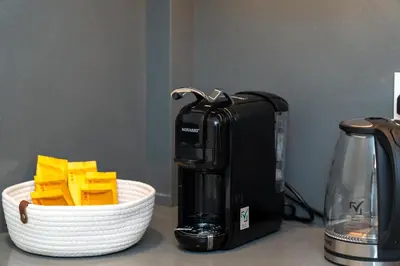 a coffee maker next to a basket of cheese at Luxury 3BR in Mada Residences - Walk to Dubai Mall in Dubai