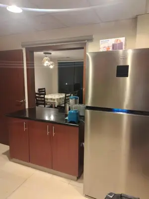 a kitchen with a stainless steel refrigerator in a room at Festive Winter Stay in JBR - Beach, Marina, Metro in Dubai