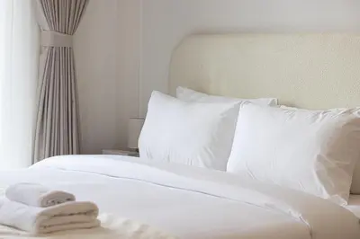 a white bed with white sheets and pillows at Emaar 52 42! Iconic Sea-View! Dubai Marina in Dubai