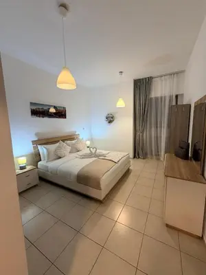 a bedroom with a bed and two pendant lights at Capital Stay - 2 Bed Apt in Business Bay in Dubai