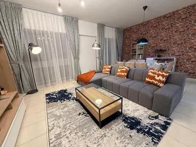a living room with a couch and a brick wall at Capital Stay - 2 Bed Apt in Business Bay in Dubai