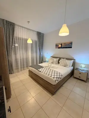 a bedroom with a large bed and a window at Capital Stay - 2 Bed Apt in Business Bay in Dubai