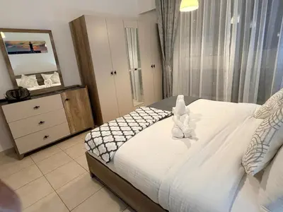 a bedroom with a bed with a teddy bear on it at Capital Stay - 2 Bed Apt in Business Bay in Dubai