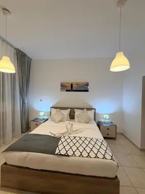a bedroom with a large bed with two lamps at Capital Stay - 2 Bed Apt in Business Bay in Dubai