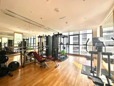 a gym with several treadmills and machines in a room at Warm & Stylish Studio with Balcony in Dubai