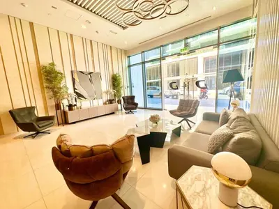 a living room with a couch and a table at Warm & Stylish Studio with Balcony in Dubai