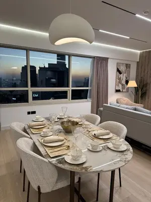a dining room with a table with chairs and a large window at Sky-High Luxury 1BR Best Views of Dubai Marina Emaar 39th Floor in Dubai