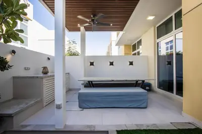 a patio with a bed and a ceiling fan at 3BR Townhouse Rooftop Terrace Just Cavalli in Dubai