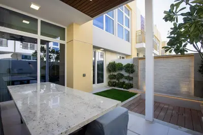 a kitchen with a table in a house at 3BR Townhouse Rooftop Terrace Just Cavalli in Dubai