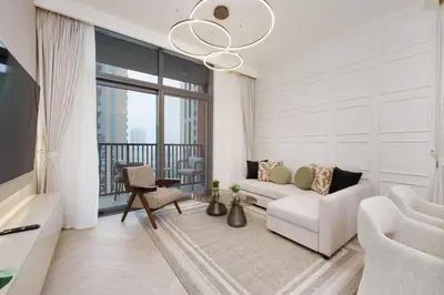 a living room with a white couch and a large window at Calm & Stylish 1Bedroom in Hadley Heights JVC in Dubai