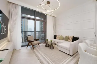 a living room with a white couch and a large window at Calm & Stylish 1Bedroom in Hadley Heights JVC in Dubai