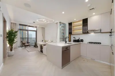 a kitchen with white cabinets and a counter top at Calm & Stylish 1Bedroom in Hadley Heights JVC in Dubai