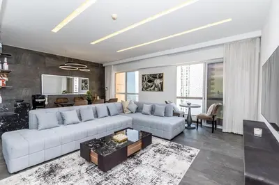 a living room with a white couch and a table at Luxury 2BR Sea View Jumeirah Beach Residence in Dubai