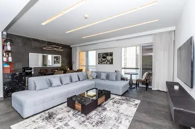a living room with a white couch and a table at Luxury 2BR Sea View Jumeirah Beach Residence in Dubai