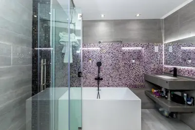 a bathroom with a shower and a tub and a sink at Luxury 2BR Sea View Jumeirah Beach Residence in Dubai