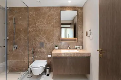 a bathroom with a toilet and a sink and a shower at Grand Bleu 1, Emaar Beachfront - Mint Stay in Dubai