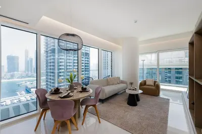 a living room with a couch and a table at Grand Bleu, Emaar Beachfront - The Mint Stay in Dubai
