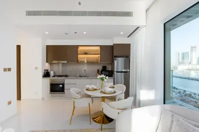 a kitchen and dining room with a table and chairs at Grand Bleu, Emaar Beachfront - The Mint Stay in Dubai