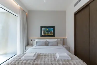 a bedroom with a large white bed with two pillows at Grand Bleu, Emaar Beachfront - The Mint Stay in Dubai