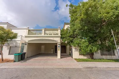 a white house with a balcony on top of it at Luxury Spacious 5 bed Villa Pool and Garden in Dubai