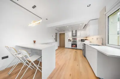 a kitchen with white counters and white appliances at Luxury Spacious 5 bed Villa Pool and Garden in Dubai