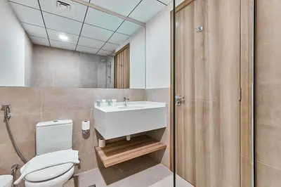 a bathroom with a white toilet and a sink at 2BHK Canal View Stay-Business Bay in Dubai