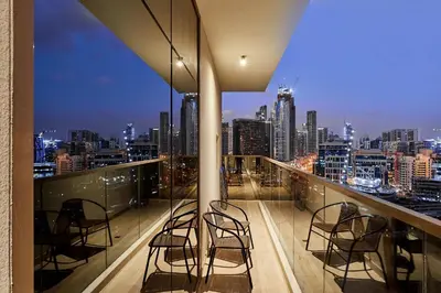 a balcony with chairs and a view of a city at 2BHK Canal View Stay-Business Bay in Dubai