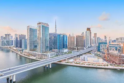 a large city with a bridge over a river at 2BHK Canal View Stay-Business Bay in Dubai