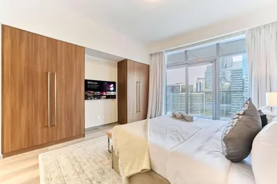 a bedroom with a large bed and a large window at Stunning Burj Khalifa View 3BR Imperial Avenue in Dubai