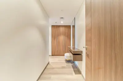 a hallway with a desk and a chair in a room at Stunning Burj Khalifa View 3BR Imperial Avenue in Dubai