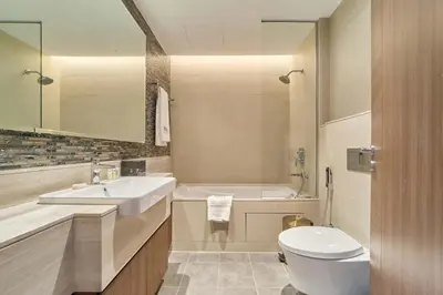 a bathroom with a sink and a toilet and a tub at Stunning Burj Khalifa View 3BR Imperial Avenue in Dubai