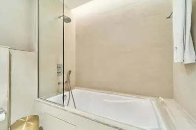 a bathroom with a tub and a shower at Stunning Burj Khalifa View 3BR Imperial Avenue in Dubai