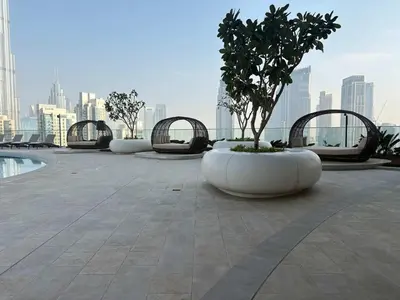 a row of white planters with trees on a building at Stunning Burj Khalifa View 3BR Imperial Avenue in Dubai