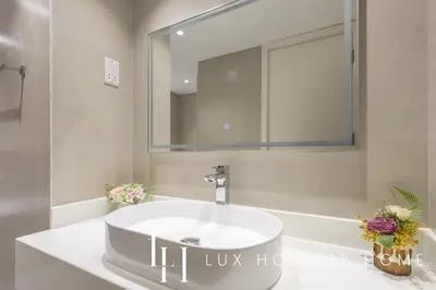 a bathroom with a white sink and a mirror at LUX The Serene Springs Villa 2 in Dubai