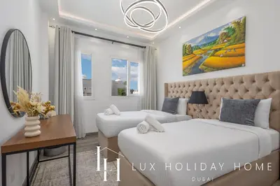 a hotel room with two beds and a desk at LUX The Serene Springs Villa 2 in Dubai
