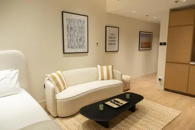 a living room with a couch and a coffee table at Stylish cozy studio in the heart of Business Bay in Sabkhah