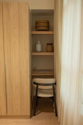 a stool in a closet with a table in it at Stylish cozy studio in the heart of Business Bay in Sabkhah