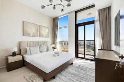 a bedroom with a bed and a large window at Cozy 1BR Near Metro in Starz Tower 2 in Dubai