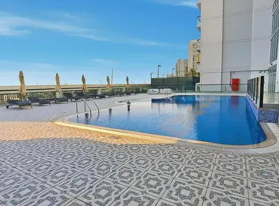 a swimming pool in the middle of a building at Cozy 1BR Near Metro in Starz Tower 2 in Dubai