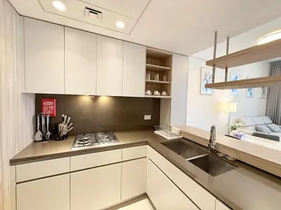 a kitchen with white cabinets and a sink at Cozy & Stylish 1BR in Wilton Terraces in Dubai