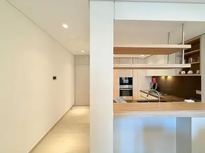 a kitchen with white walls and a counter top at Cozy & Stylish 1BR in Wilton Terraces in Dubai