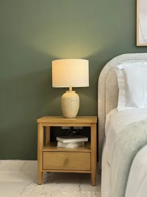a lamp on a night stand next to a bed at Fresh & Modern Studio in Meydan - Azizi Riviera 67 in Dubai