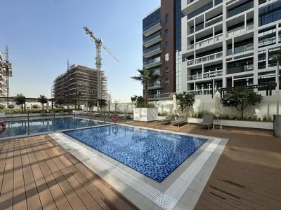 a swimming pool in the middle of a building at Fresh & Modern Studio in Meydan - Azizi Riviera 67 in Dubai