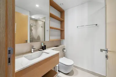 a bathroom with a sink and a toilet at Elegant 2BR Close to Park in Park Horizon in Dubai