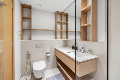 a bathroom with a toilet and a sink and a shower at Elegant 2BR Close to Park in Park Horizon in Dubai