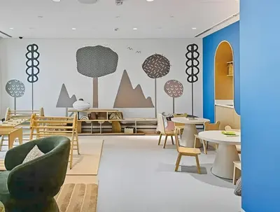a dining room with tables and chairs and a wall at Elegant 2BR Close to Park in Park Horizon in Dubai