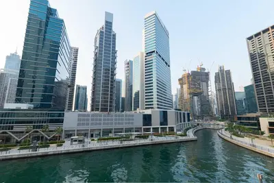a river in a city with tall buildings at Escape24 Brand New 2BR with Canal Views near Burj Khalifa in Dubai